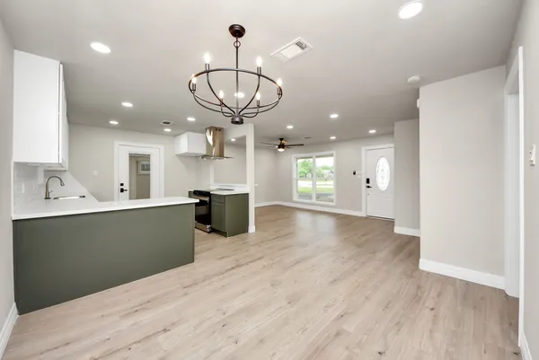 a view of kitchen and a chandelier fan