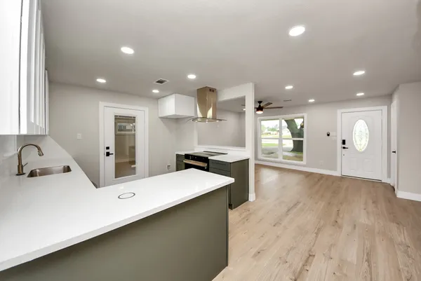 a large kitchen with a large counter top appliances and cabinets