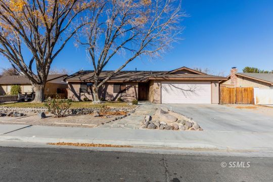 321 South Locust Street Ridgecrest, CA 93555 - Photo 1 of 30 a front view of a house with a yard