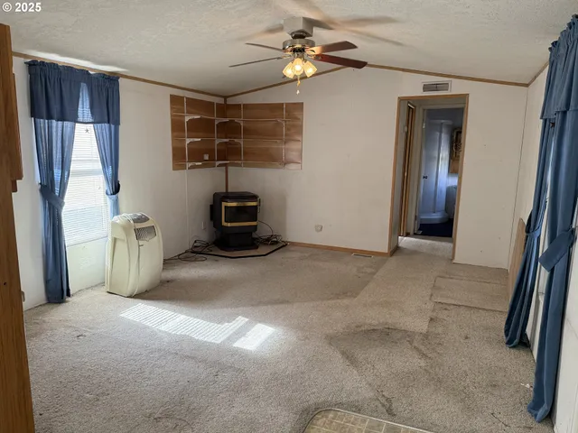 a view of a livingroom with furniture and a ceiling fan