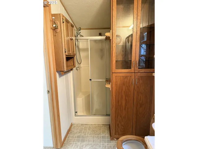 a bathroom with a shower and a sink