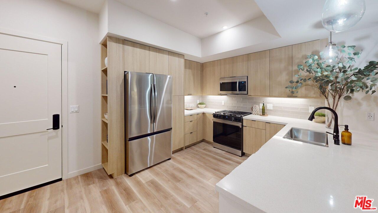 800 North Front Street, Unit 1539 Burbank, CA 91502 - Photo 3 of 7 a kitchen with granite countertop a refrigerator and a sink