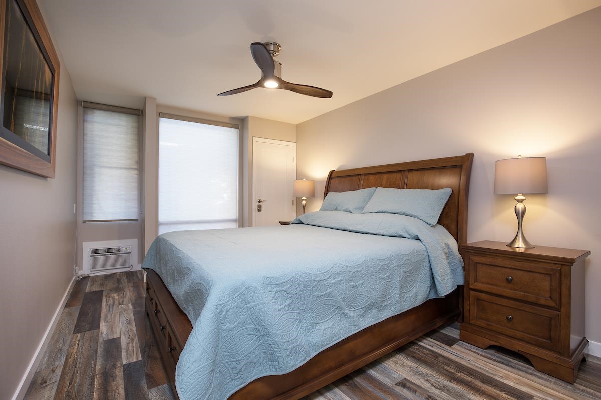 2737 South Kihei Road, Unit 126 Kihei, HI 96753 - Photo 12 of 25 a bedroom with a bed and a chandelier