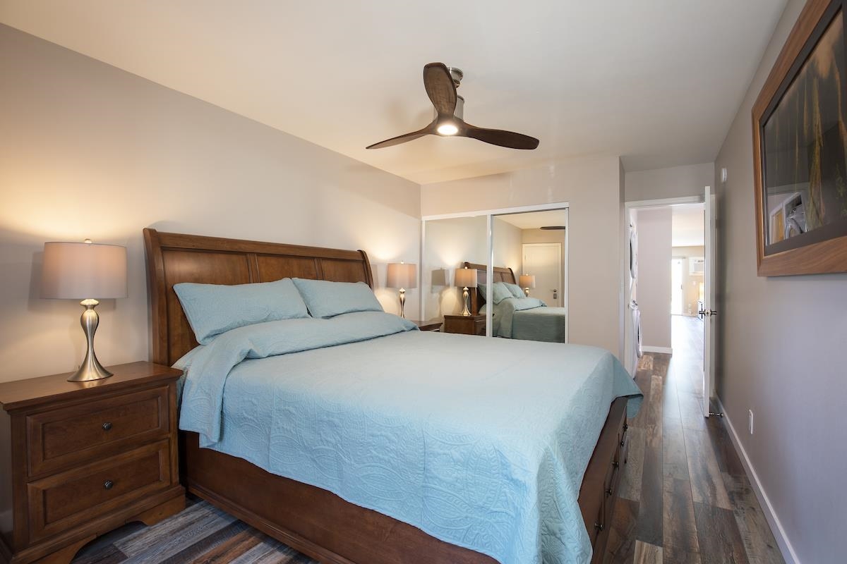 2737 South Kihei Road, Unit 126 Kihei, HI 96753 - Photo 13 of 25 a bedroom with a bed and a chandelier