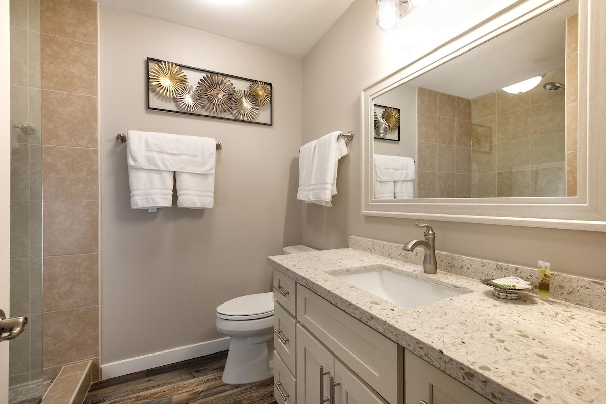 2737 South Kihei Road, Unit 126 Kihei, HI 96753 - Photo 14 of 25 a bathroom with a granite countertop sink mirror vanity and toilet