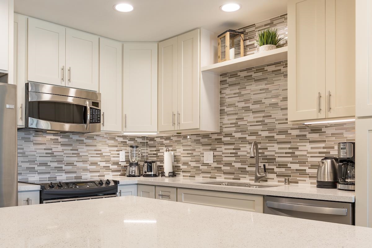 2737 South Kihei Road, Unit 126 Kihei, HI 96753 - Photo 4 of 25 a kitchen with stainless steel appliances and cabinets