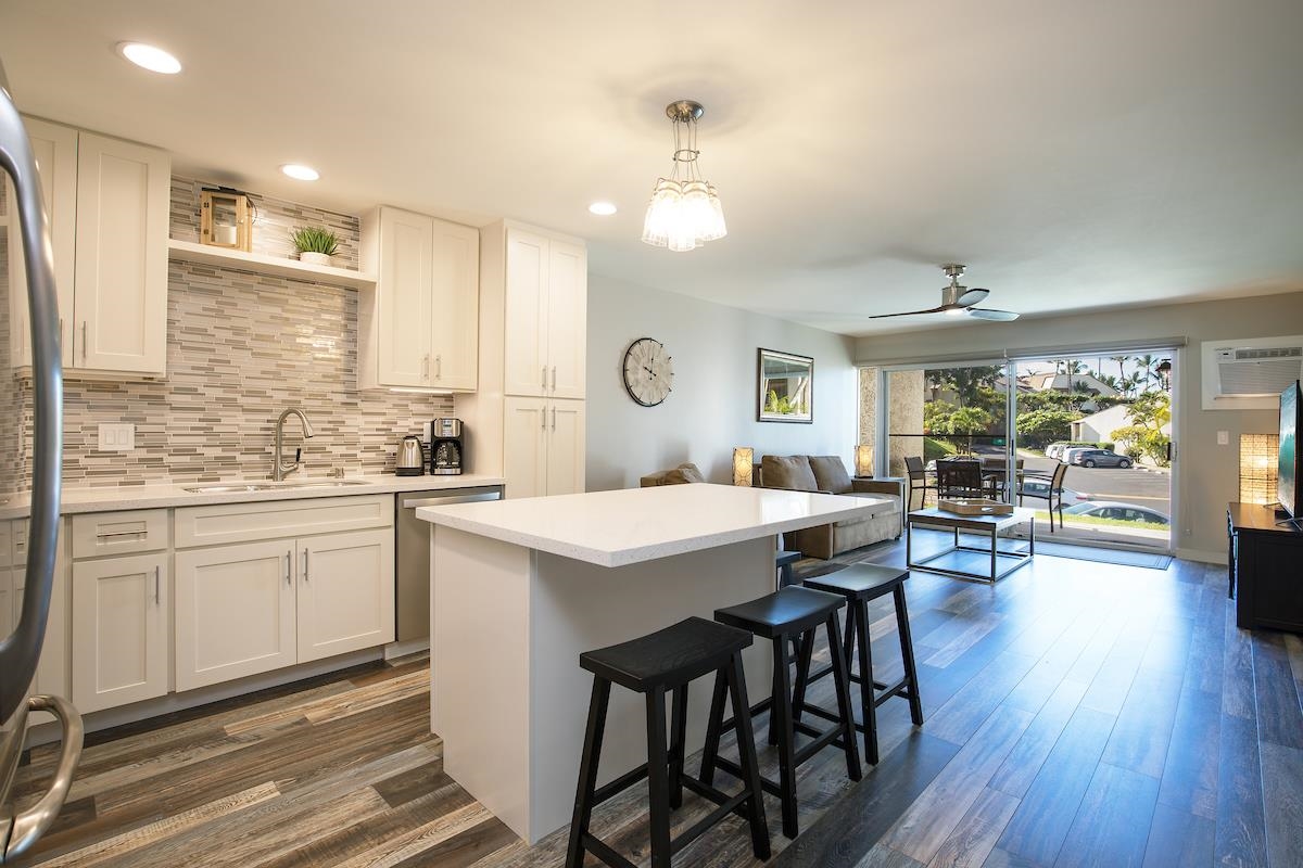 2737 South Kihei Road, Unit 126 Kihei, HI 96753 - Photo 9 of 25 a open kitchen with sink cabinets and wooden floor