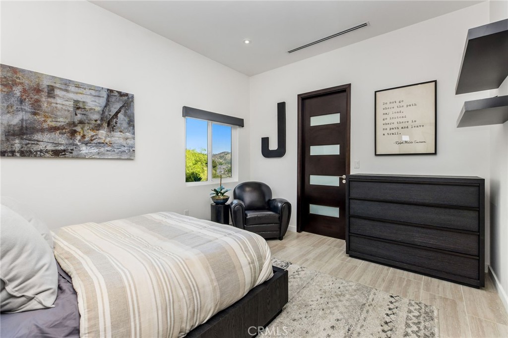 207 Saddlebow Road Bell Canyon, CA 91307 - Photo 18 of 33 a bedroom with a bed and a painting on the wall