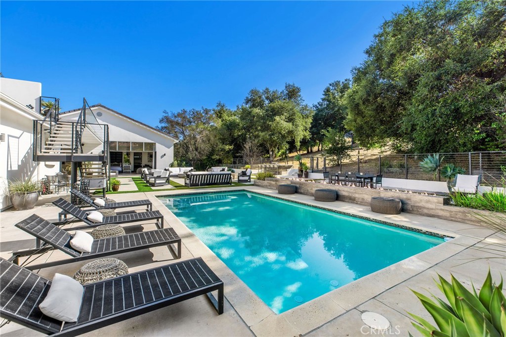 207 Saddlebow Road Bell Canyon, CA 91307 - Photo 24 of 33 a view of a patio with chairs and a table and chairs with wooden floor and fence