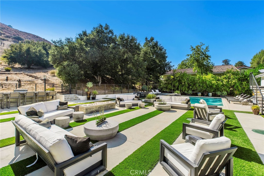207 Saddlebow Road Bell Canyon, CA 91307 - Photo 26 of 33 a view of a patio with couches chairs and a fire pit
