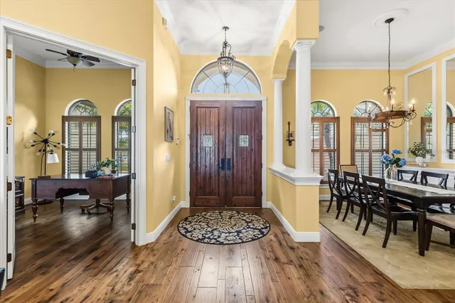 a view of a a dining room with furniture window and wooden floor