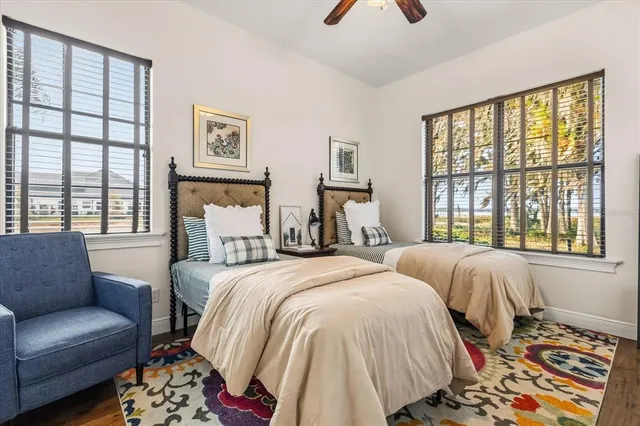 a view of a hallway with wooden floor and bathroom