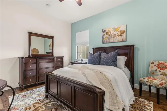 a view of a brick house with a large windows and palm trees