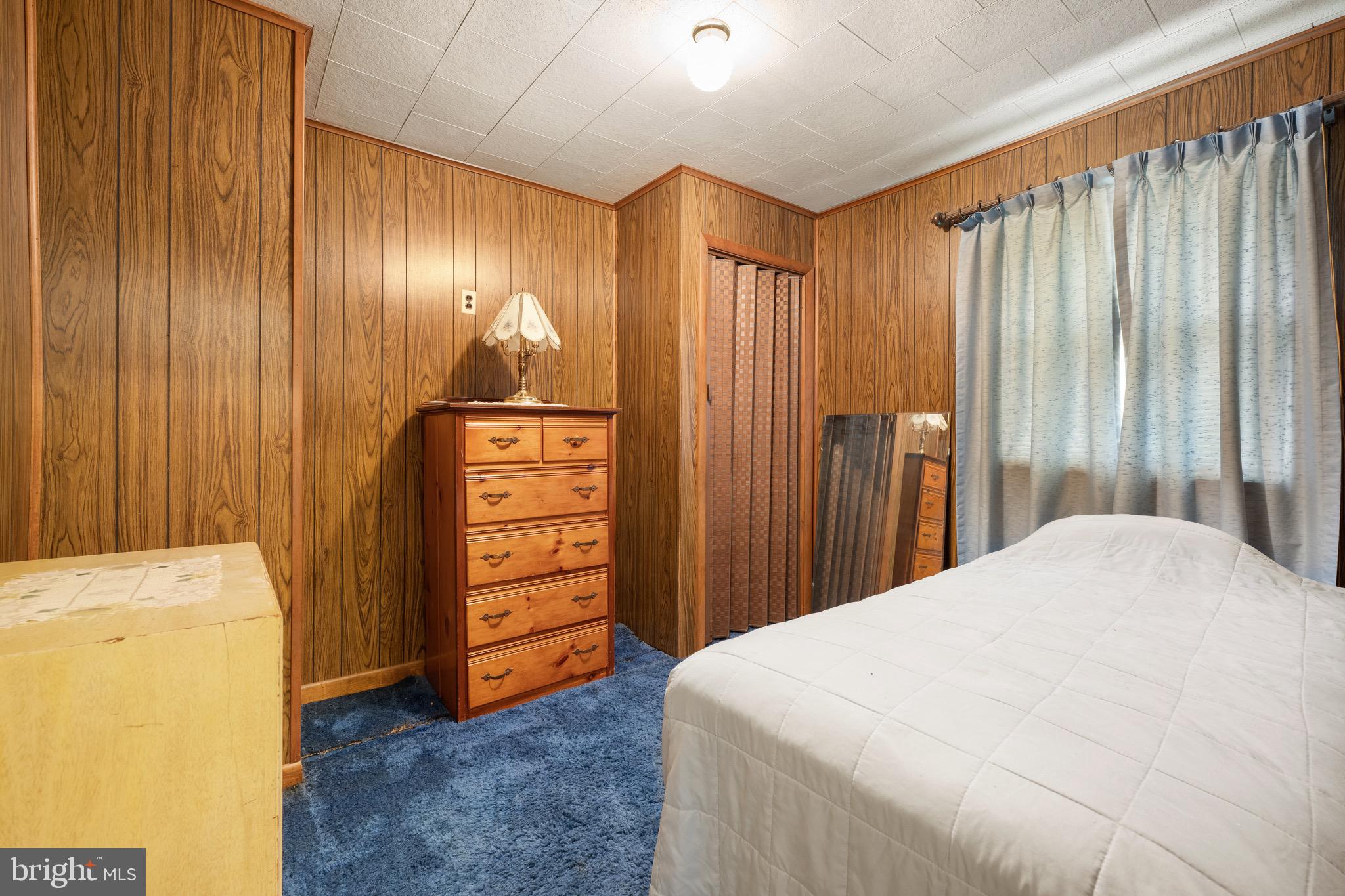 302 Tyler Avenue Carneys Point, NJ 08069 - Photo 19 of 27 a bedroom with a bed and a dresser