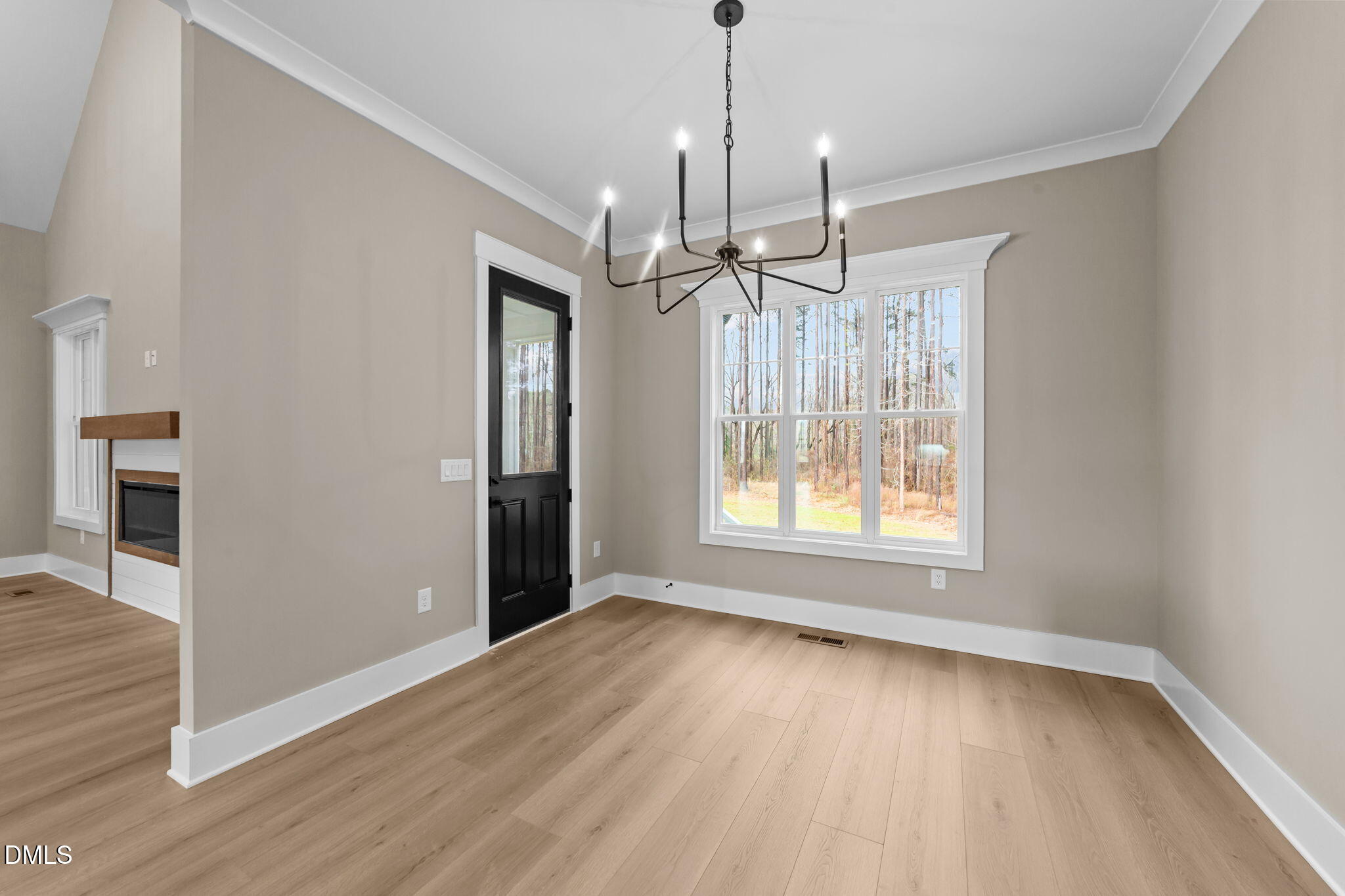 2590 Lassiter Road Four Oaks, NC 27524 - Photo 23 of 72 a view of an empty room with wooden floor fireplace and a window