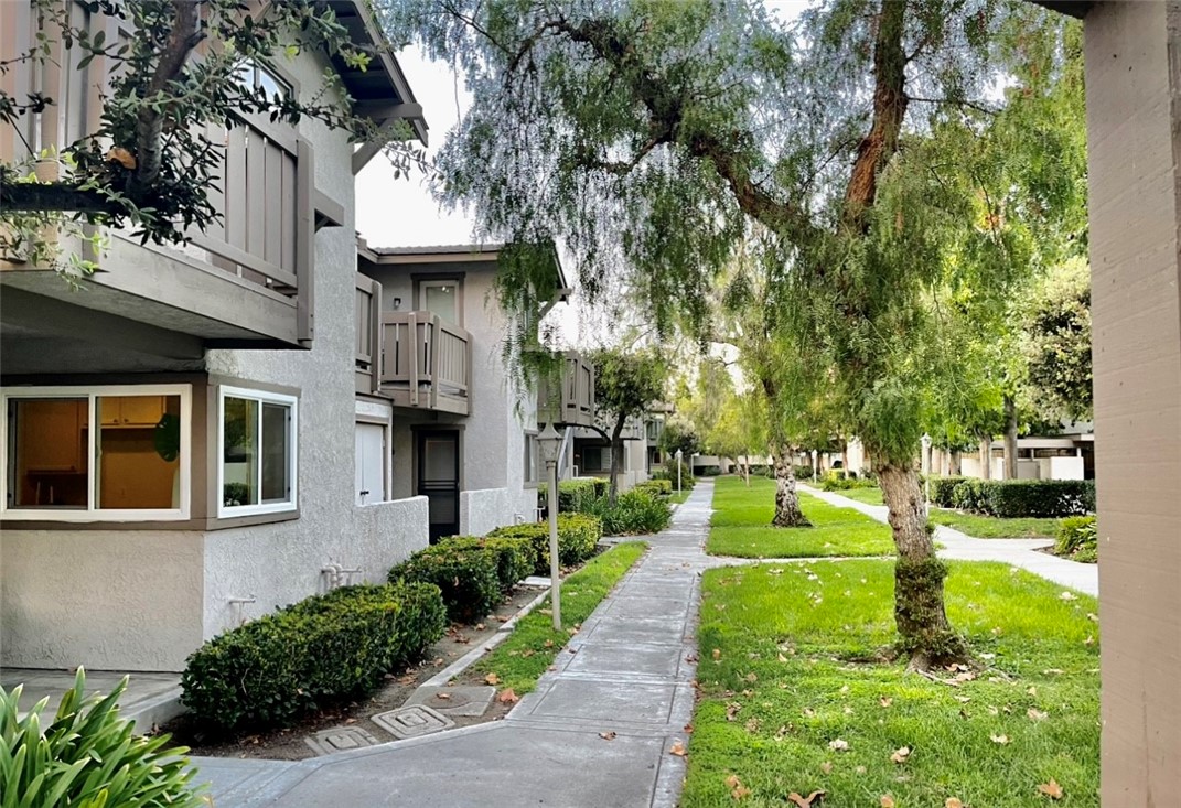 35 Smokestone, Unit 33 Irvine, CA 92614 - Photo 1 of 1 front view of a building with a yard
