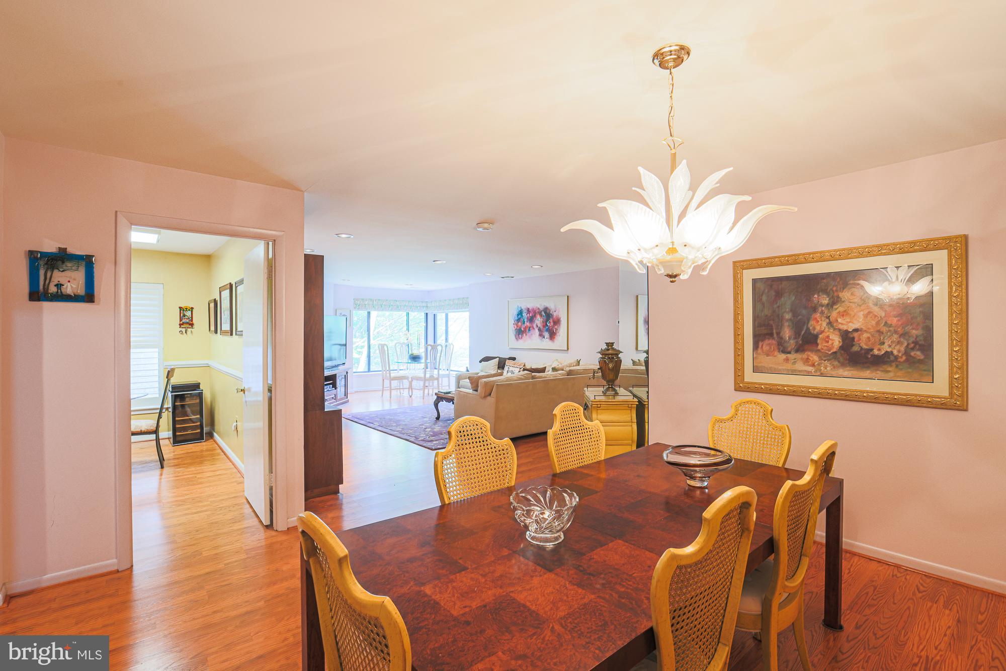 3041 Fallstaff Road, Unit 304D Baltimore, MD 21209 - Photo 11 of 39 a view of a dining room with furniture a chandelier and wooden floor