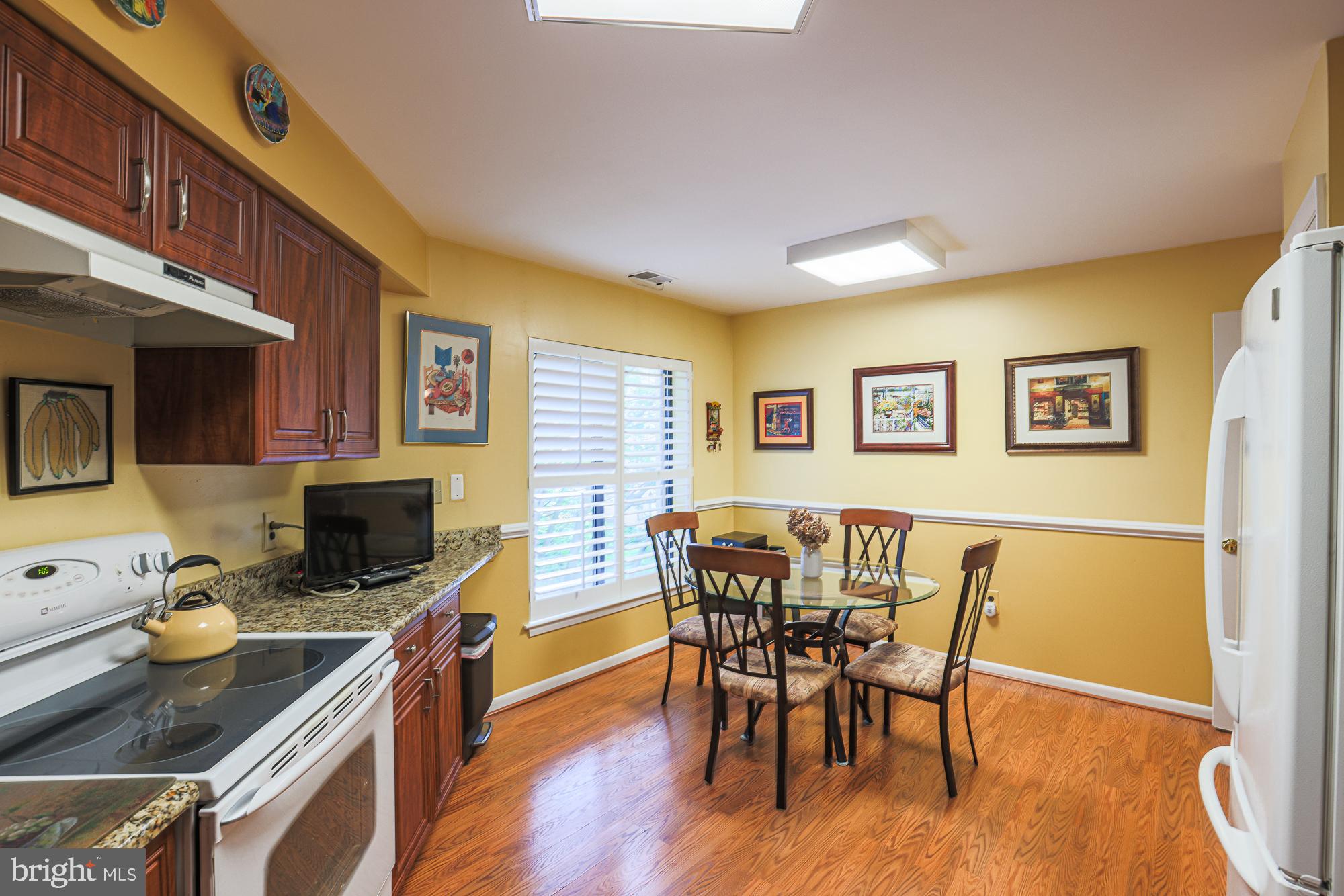 3041 Fallstaff Road, Unit 304D Baltimore, MD 21209 - Photo 27 of 39 a view of a dining room with furniture and wooden floor