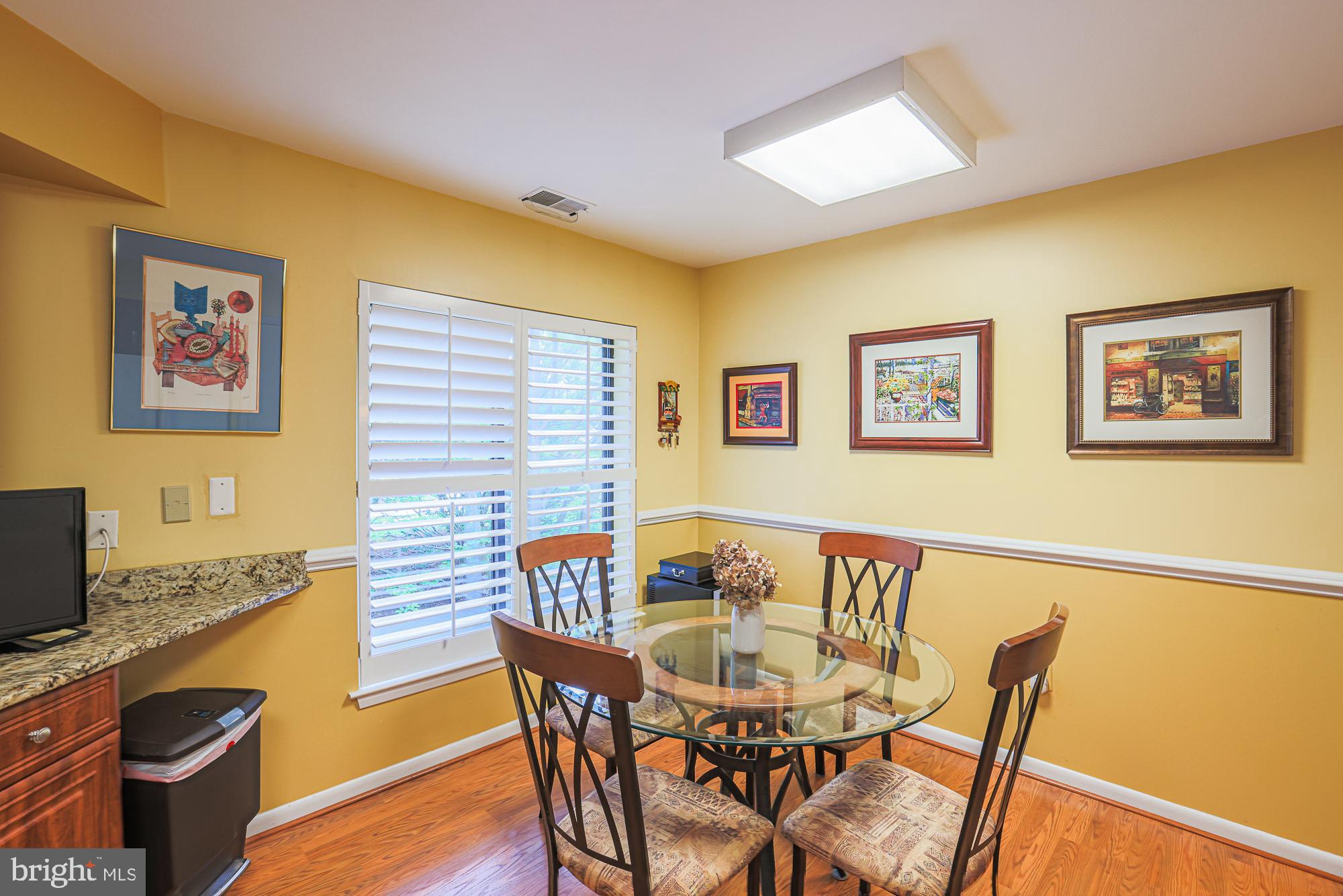 3041 Fallstaff Road, Unit 304D Baltimore, MD 21209 - Photo 28 of 39 a view of a dining room with furniture and wooden floor