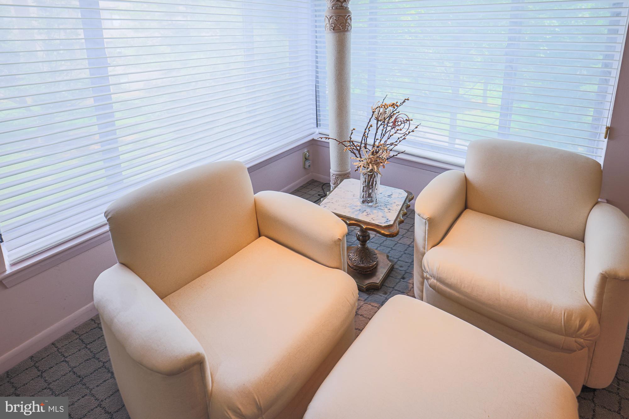 3041 Fallstaff Road, Unit 304D Baltimore, MD 21209 - Photo 36 of 39 a blue chairs sitting in a bedroom next to a window