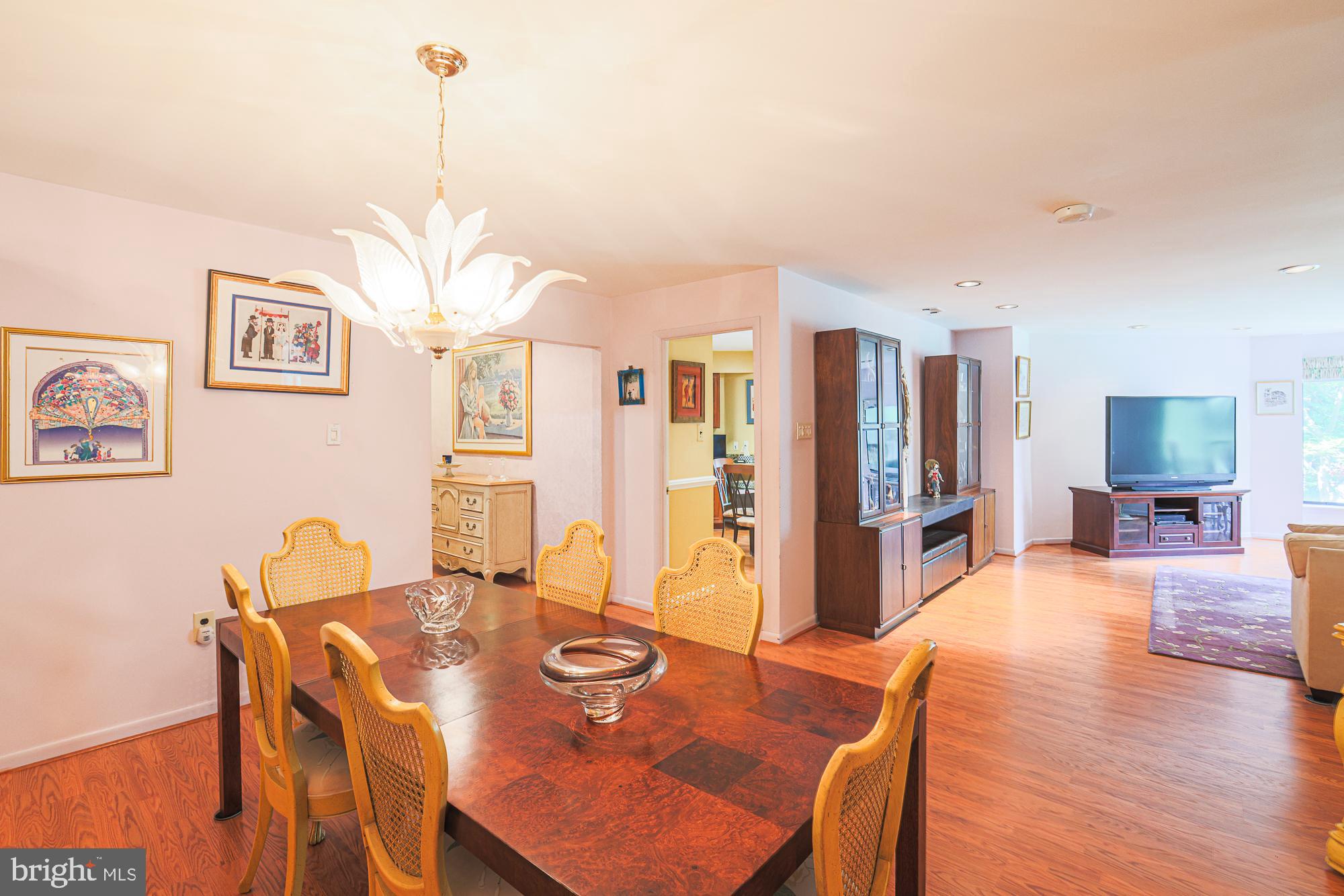 3041 Fallstaff Road, Unit 304D Baltimore, MD 21209 - Photo 10 of 39 a view of a dining room with furniture a chandelier and wooden floor