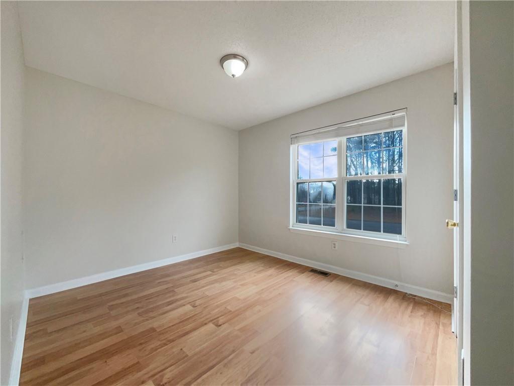 17 Cedars Glen Place Villa Rica, GA 30180 - Photo 12 of 23 a view of an empty room with wooden floor and a window
