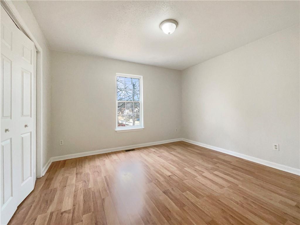 17 Cedars Glen Place Villa Rica, GA 30180 - Photo 13 of 23 an empty room with wooden floor and windows