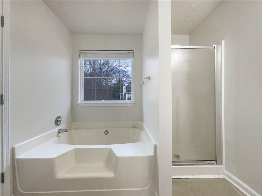17 Cedars Glen Place Villa Rica, GA 30180 - Photo 17 of 23 a white bath tub sitting next to a window