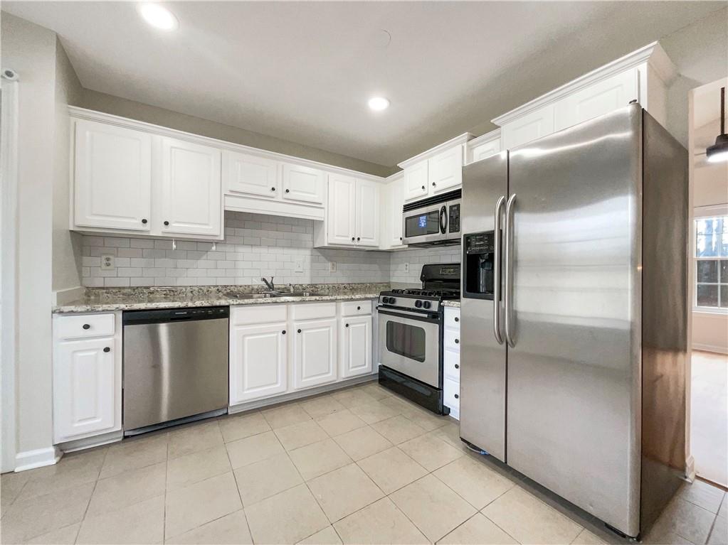 17 Cedars Glen Place Villa Rica, GA 30180 - Photo 6 of 23 a kitchen with a refrigerator sink and cabinets
