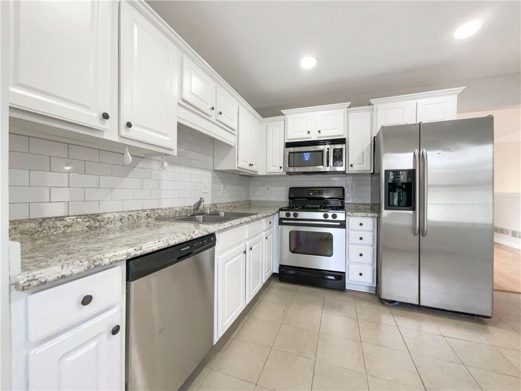 17 Cedars Glen Place Villa Rica, GA 30180 - Photo 7 of 23 a kitchen with stainless steel appliances granite countertop a refrigerator and a stove