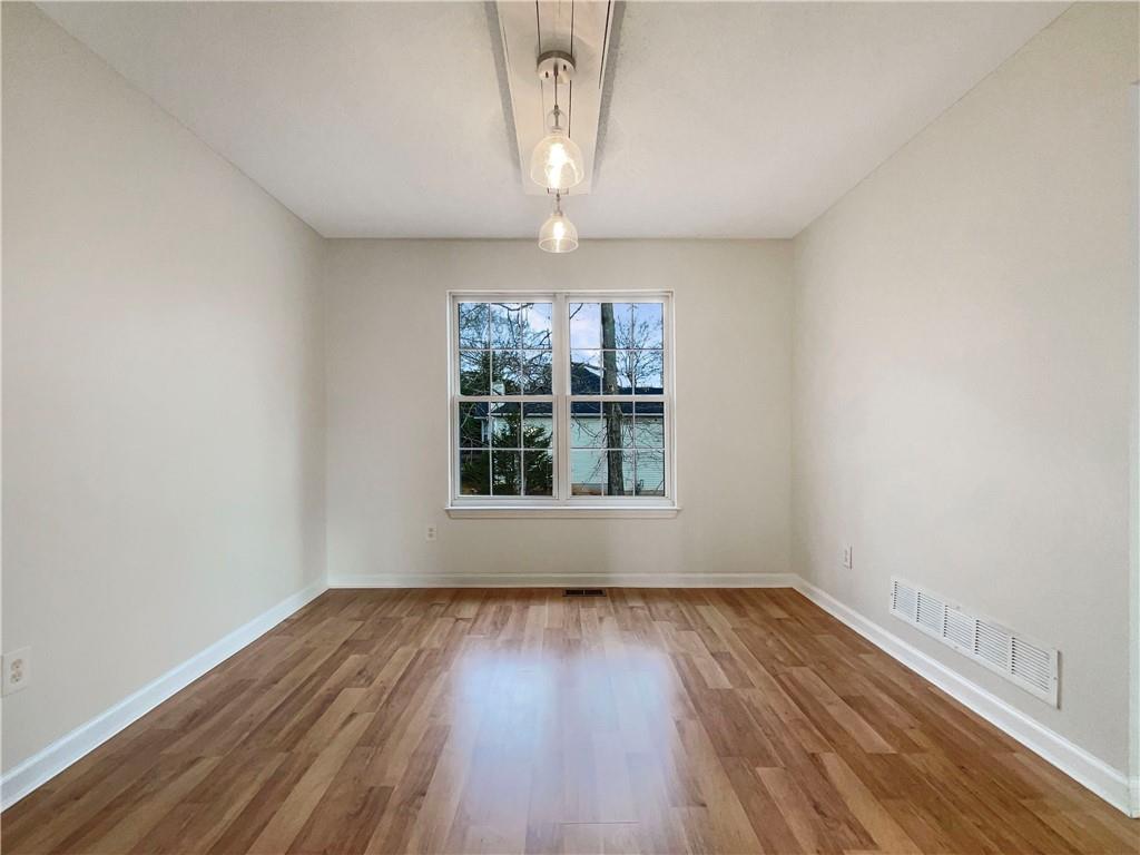 17 Cedars Glen Place Villa Rica, GA 30180 - Photo 8 of 23 wooden floor in an empty room with a window