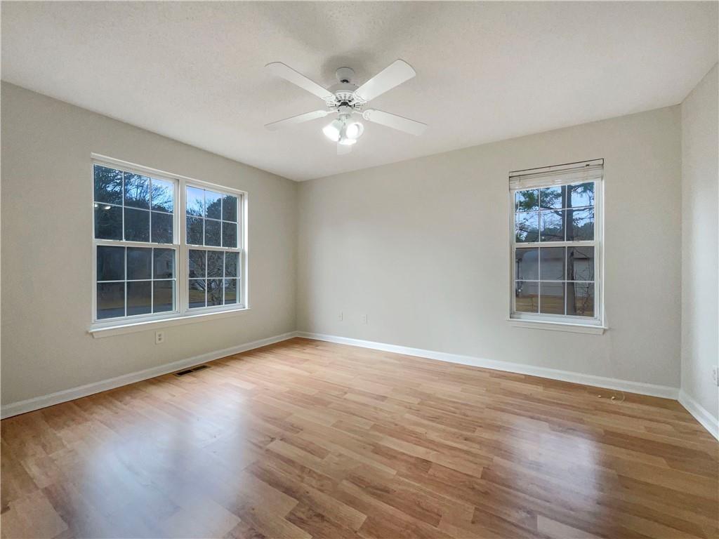 17 Cedars Glen Place Villa Rica, GA 30180 - Photo 10 of 23 a view of an empty room with wooden floor and a window