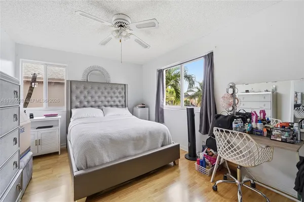 a bedroom with a bed closet and a window