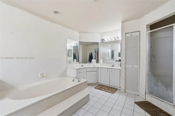 a bathroom with a double vanity sink mirror and shower