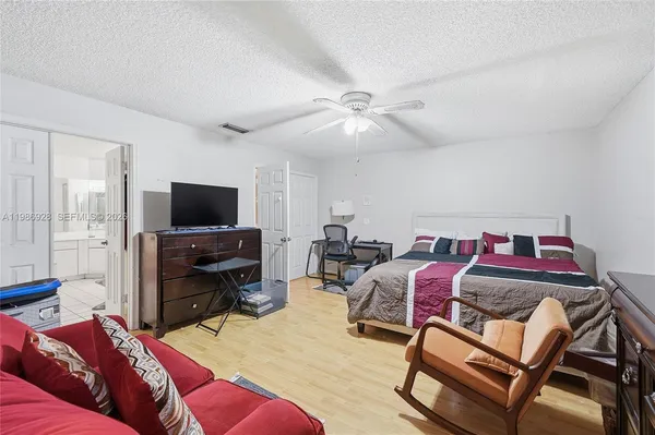 a bedroom with a bed and a flat screen tv