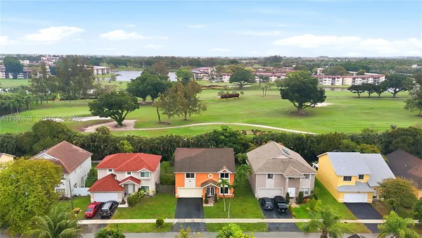 an aerial view of a house with yard swimming pool and outdoor seating