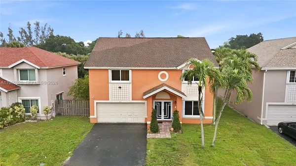 a front view of a house with a yard