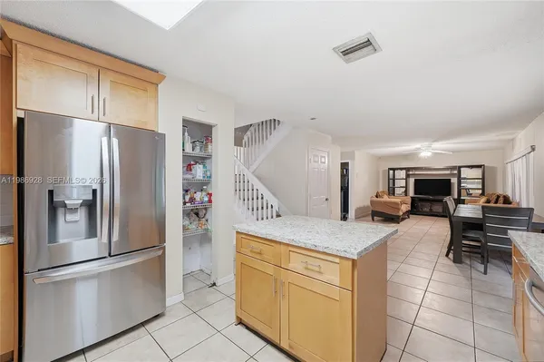 a kitchen with stainless steel appliances a refrigerator sink and cabinets