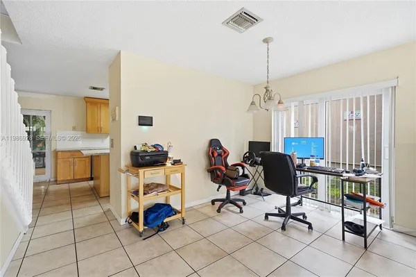 a view of a workspace with furniture and a window