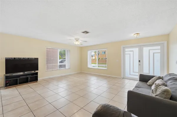 a living room with furniture and a flat screen tv