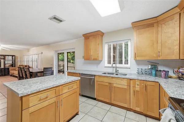 a kitchen with granite countertop a sink and cabinets
