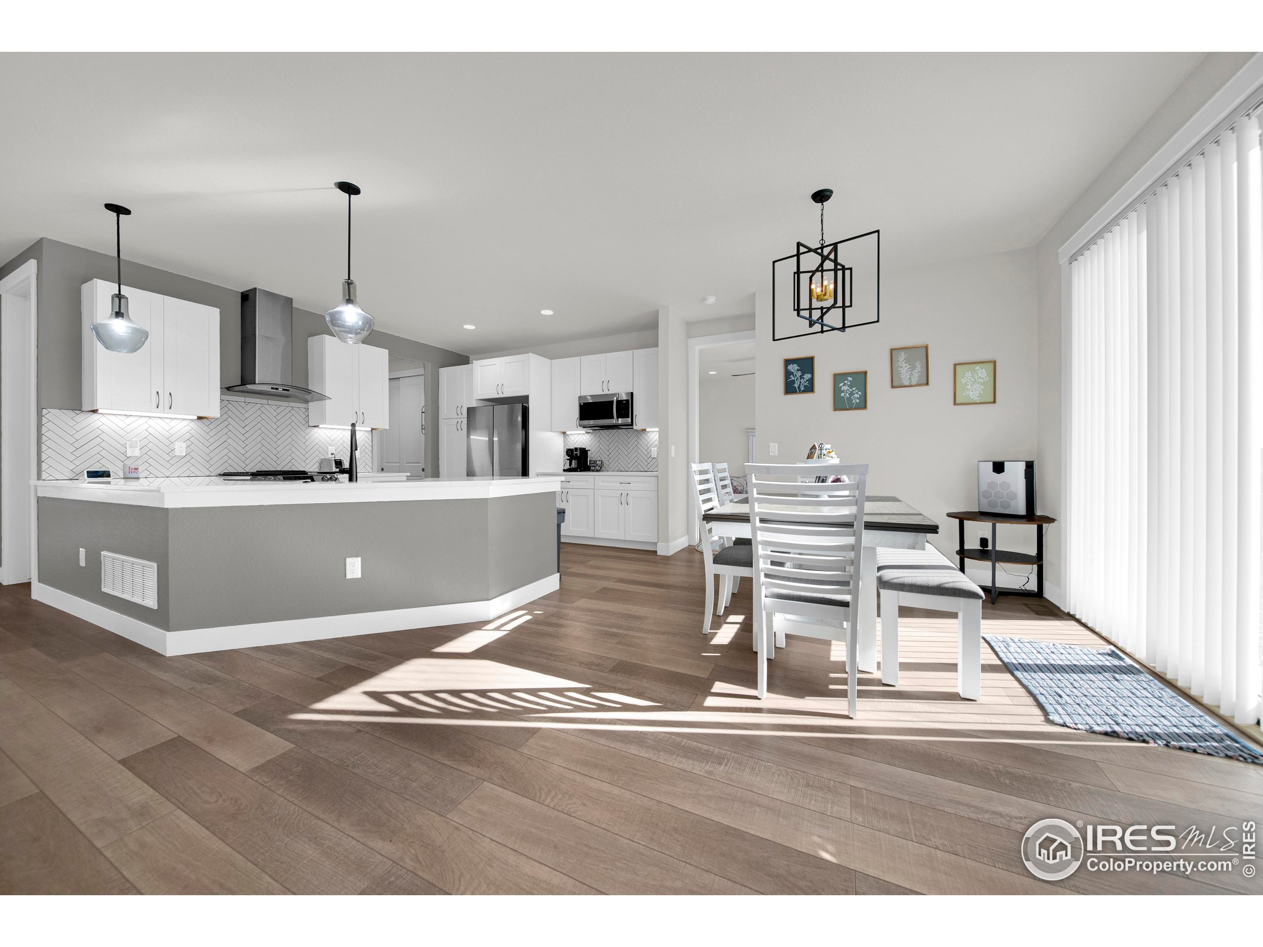 116 7th Avenue Wiggins, CO 80654 - Photo 11 of 42 a view of kitchen with wooden floor