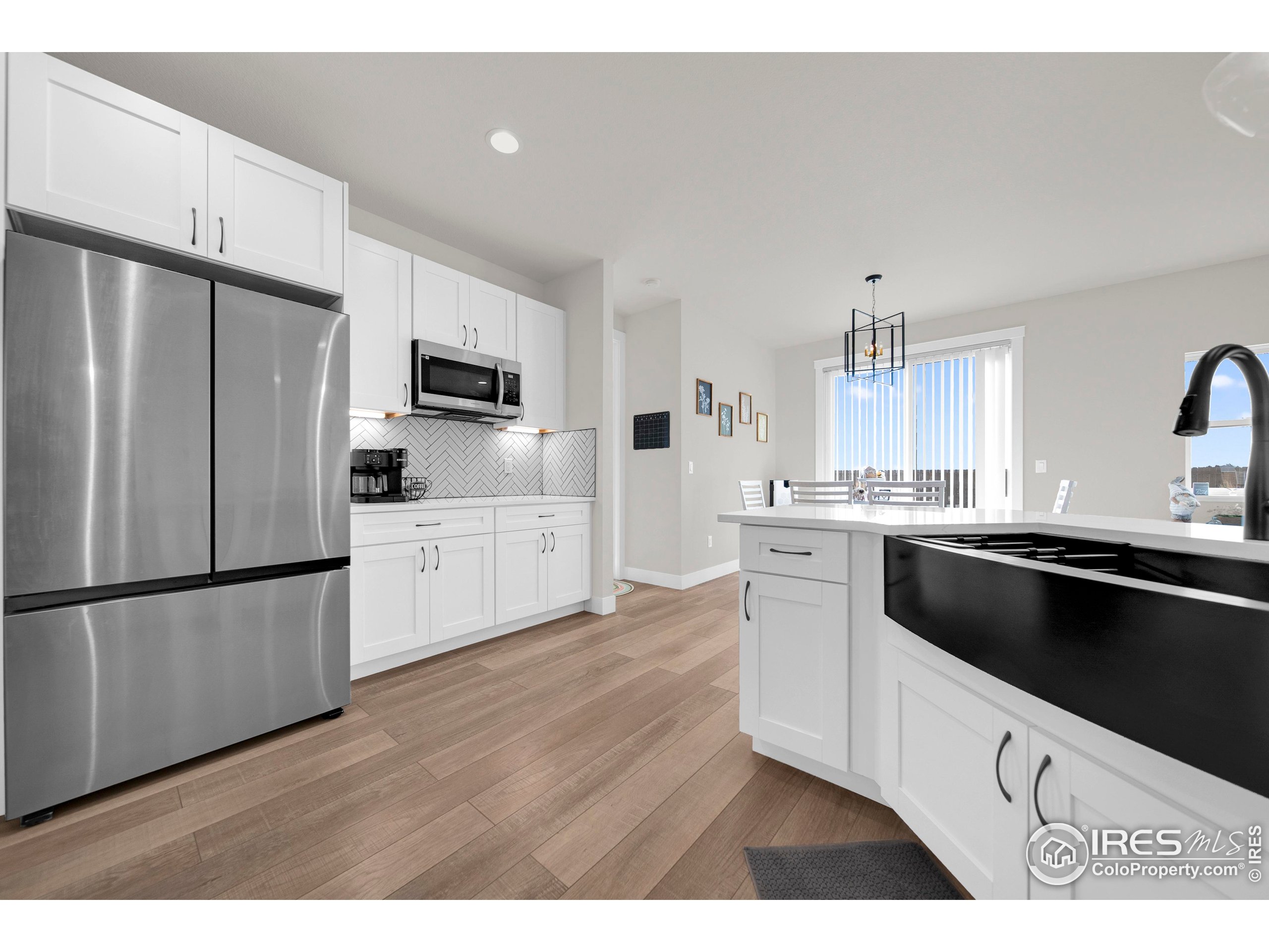 116 7th Avenue Wiggins, CO 80654 - Photo 15 of 42 a kitchen with a refrigerator sink and cabinets