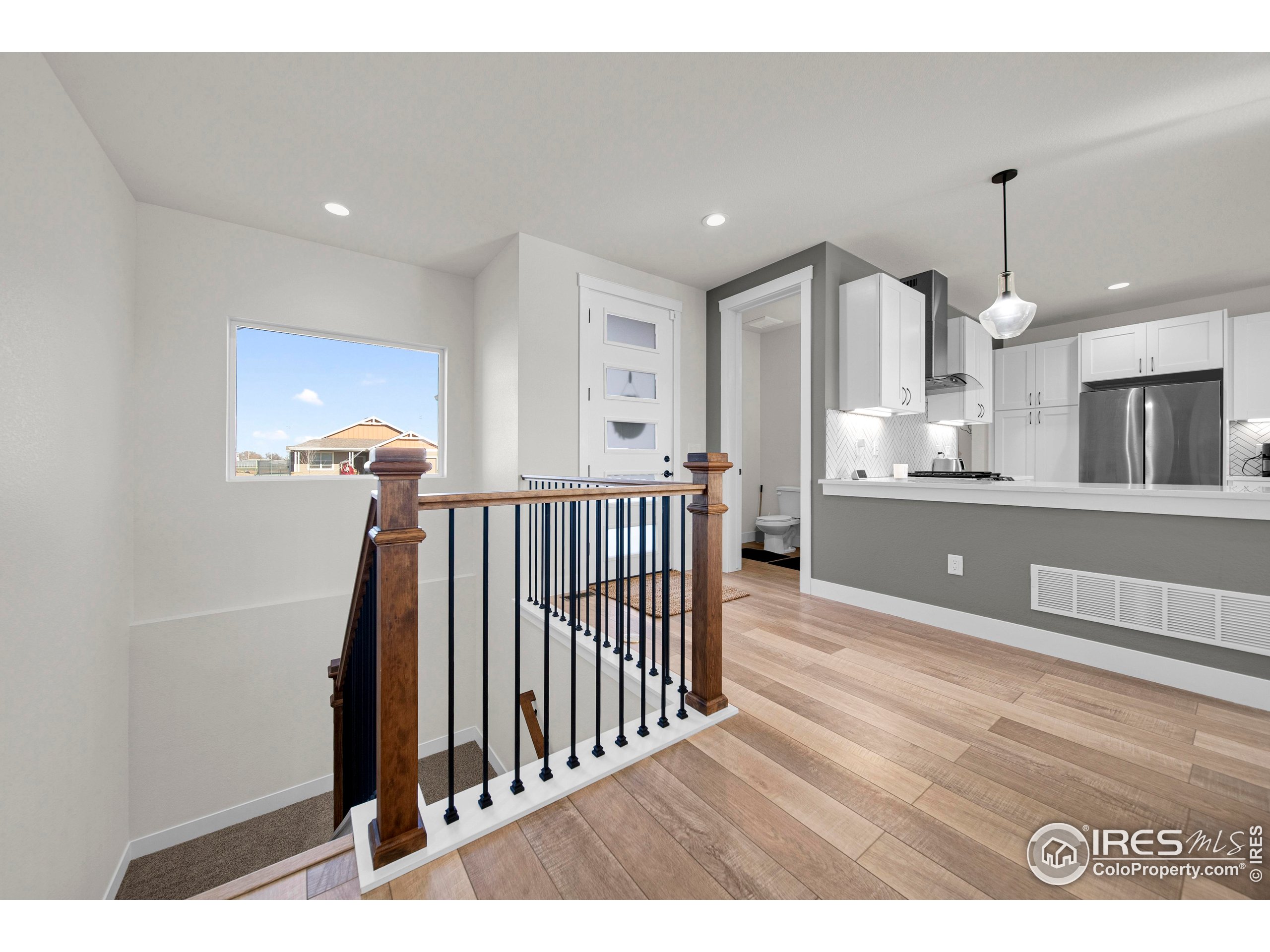 116 7th Avenue Wiggins, CO 80654 - Photo 17 of 42 a view of a living room and kitchen with furniture