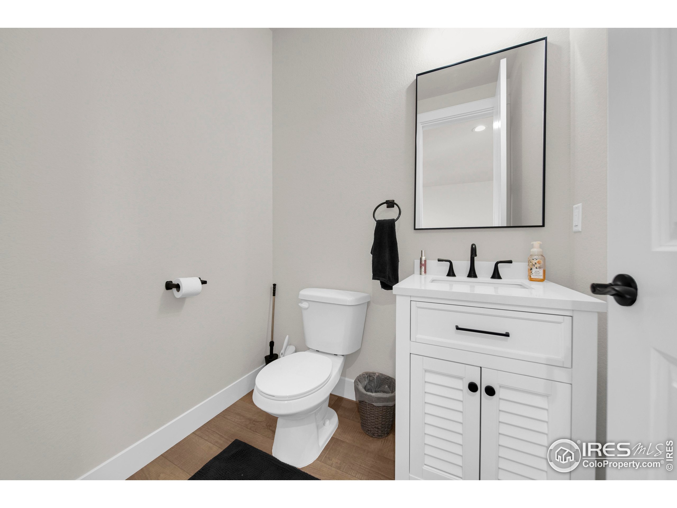 116 7th Avenue Wiggins, CO 80654 - Photo 18 of 42 a bathroom with a sink vanity mirror and toilet