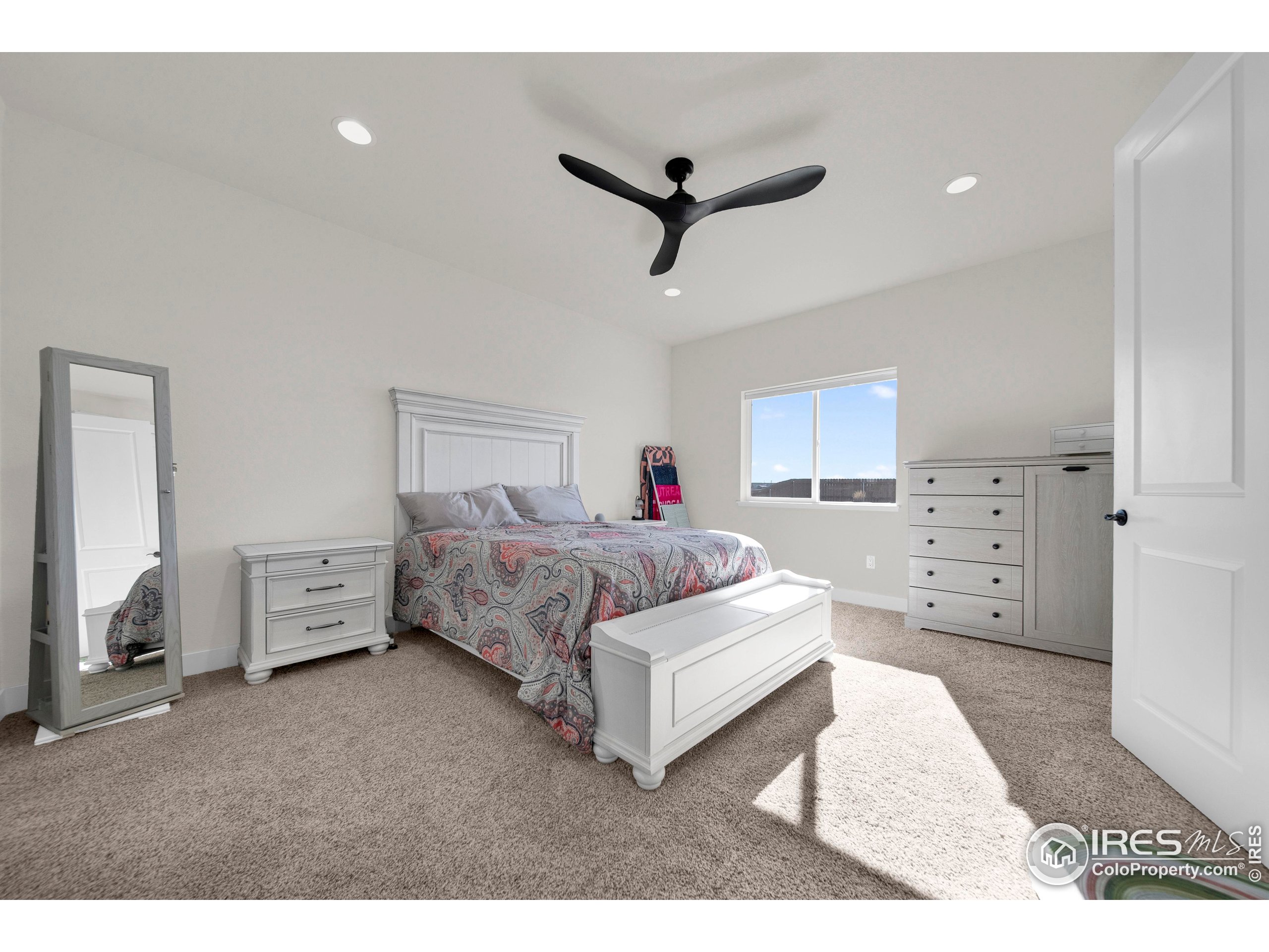 116 7th Avenue Wiggins, CO 80654 - Photo 19 of 42 a spacious bedroom with a bed and a cabinets