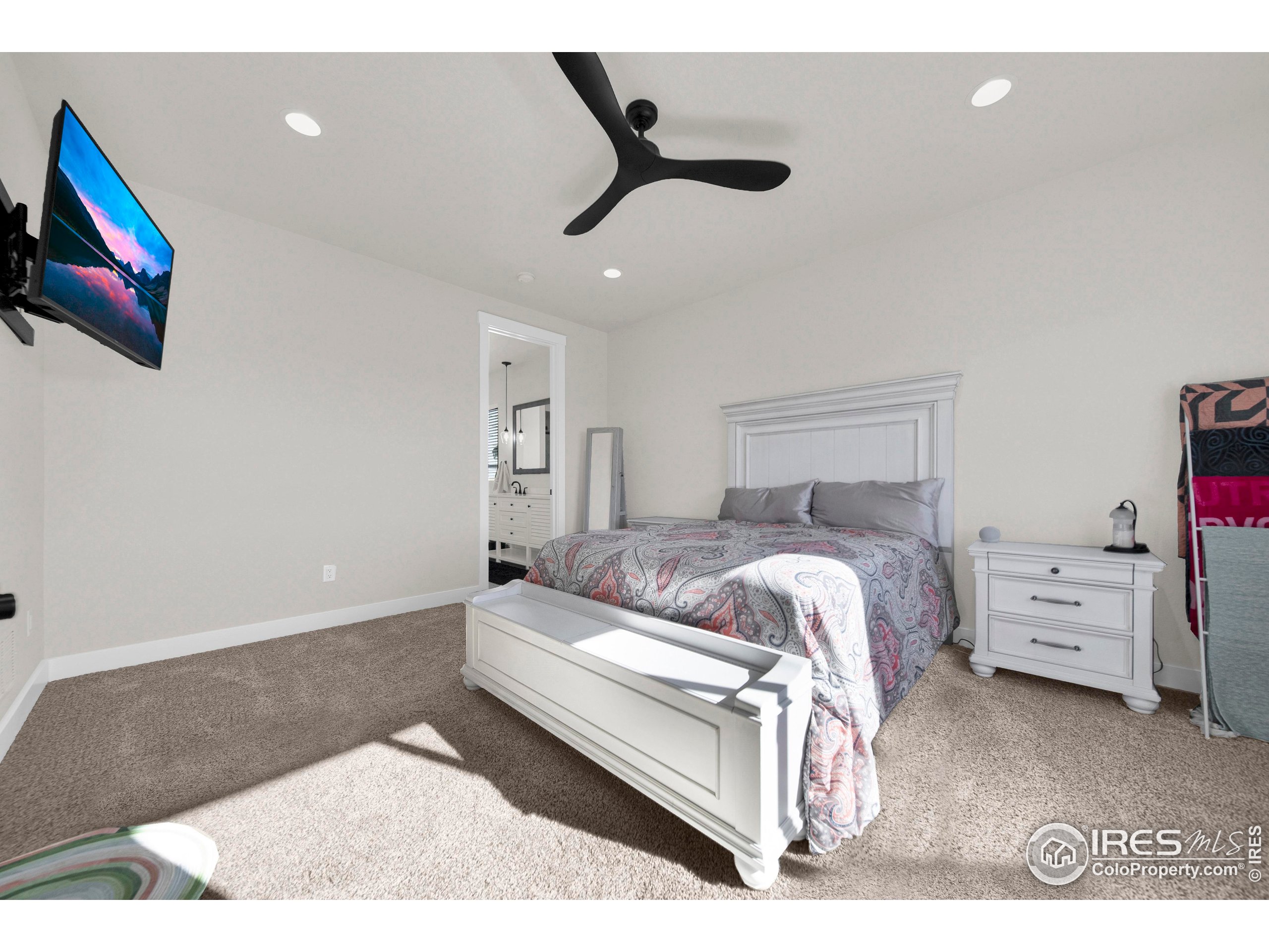 116 7th Avenue Wiggins, CO 80654 - Photo 21 of 42 a bedroom with a bed and a painting on the wall