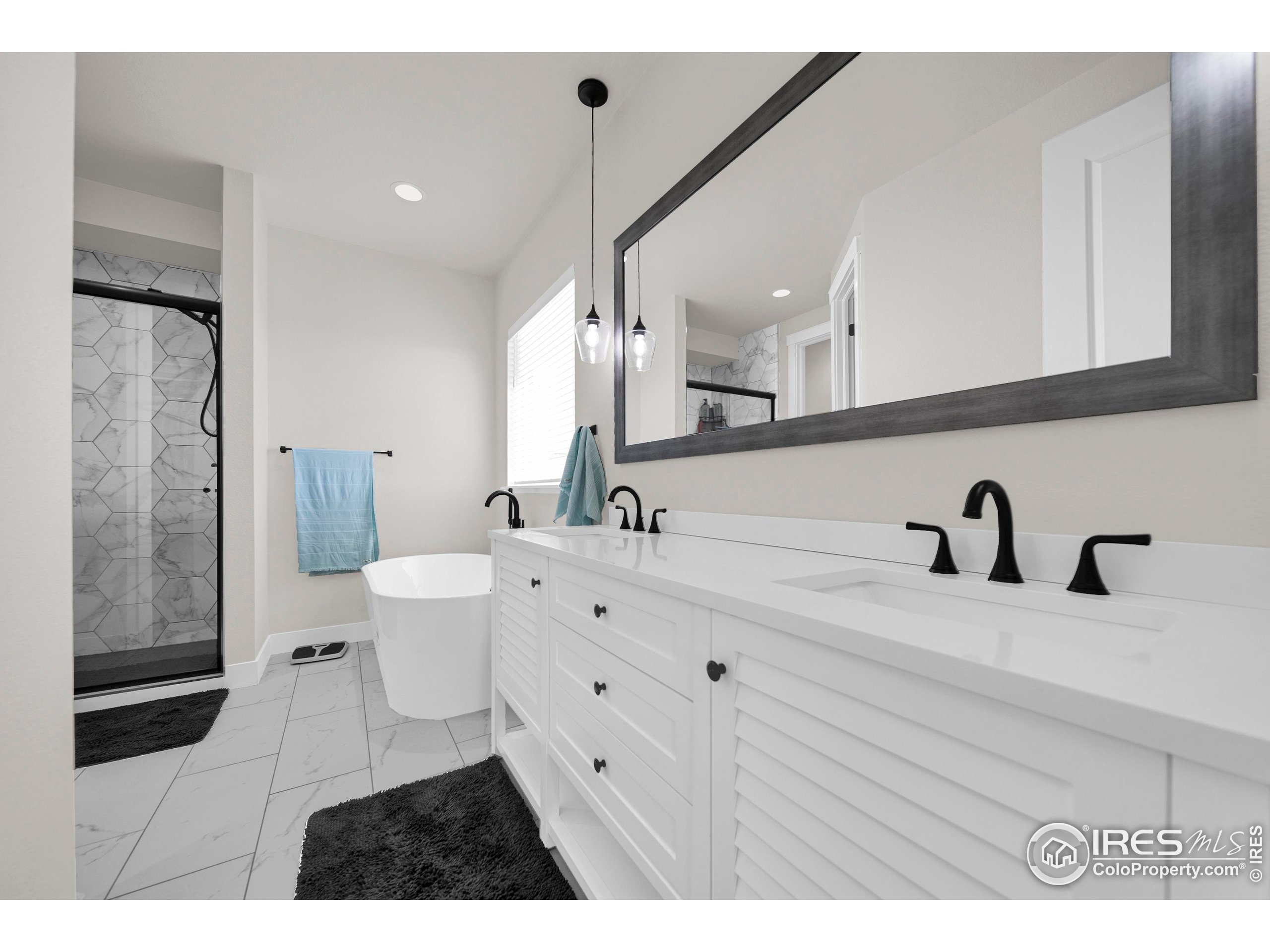 116 7th Avenue Wiggins, CO 80654 - Photo 22 of 42 a bathroom with a sink a toilet and mirror