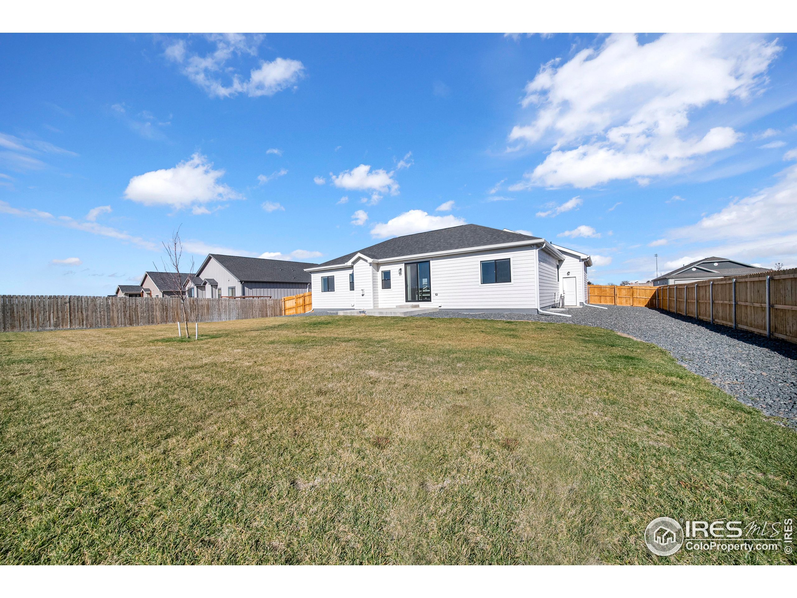 116 7th Avenue Wiggins, CO 80654 - Photo 32 of 42 a view of a house with a yard and sitting area