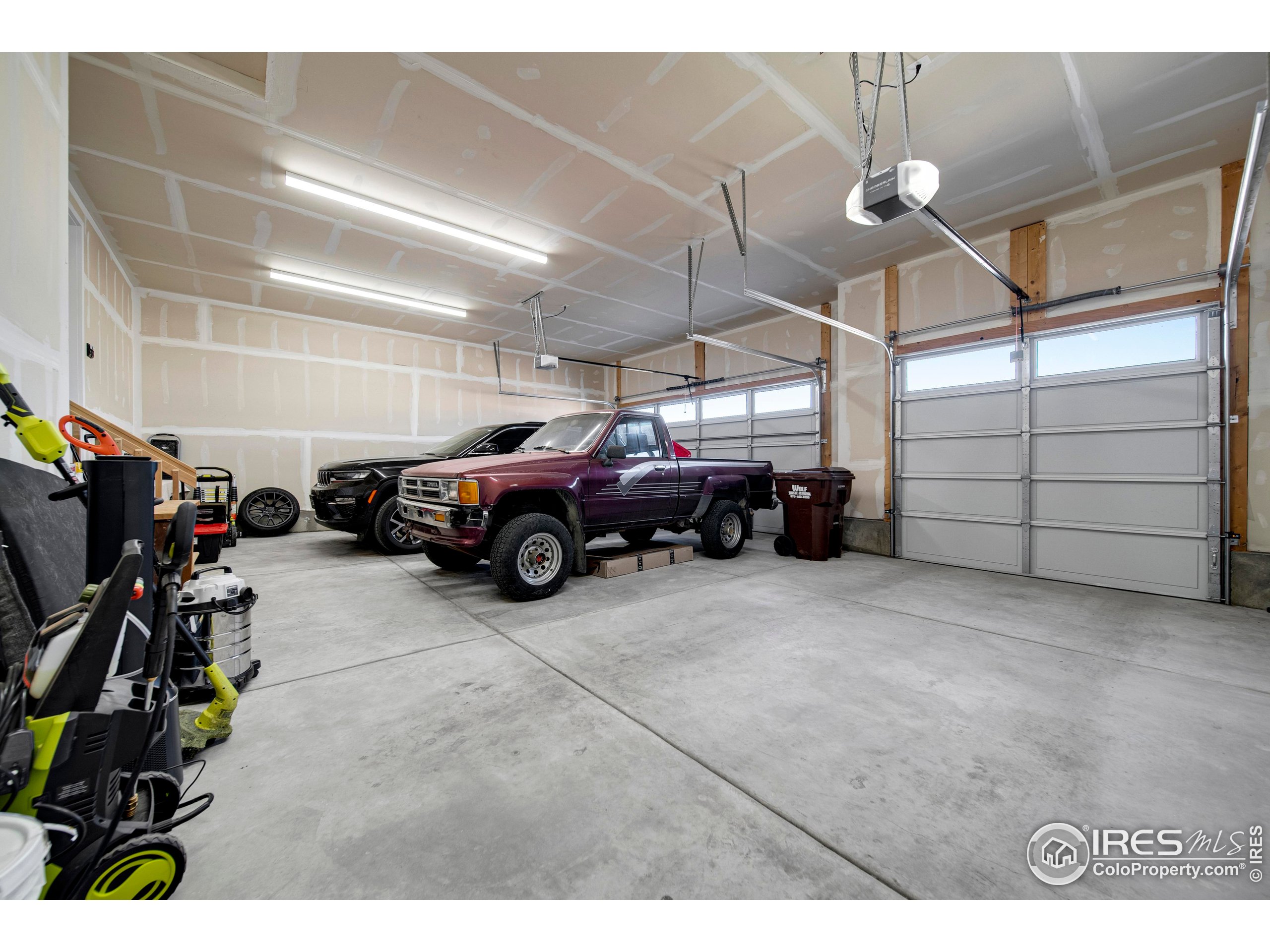 116 7th Avenue Wiggins, CO 80654 - Photo 36 of 42 a view of a garage with parked cars